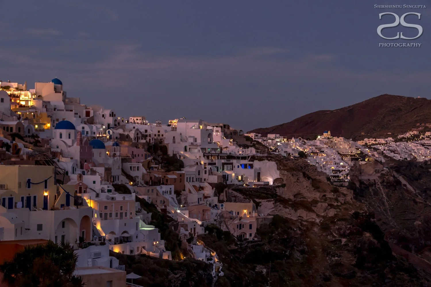 dusk at white houses church blue domes oia imerovigli firostefani fira village santorini greece caldera volcanic island