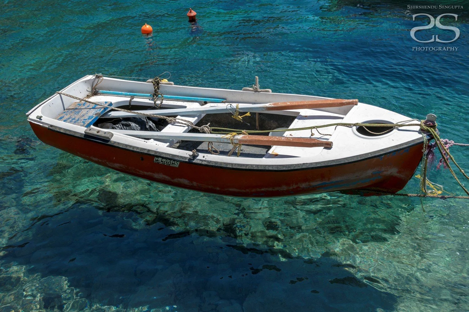 boat floating at ammoudi harbor with white houses church blue domes oia imerovigli firostefani fira village santorini greece caldera volcanic island