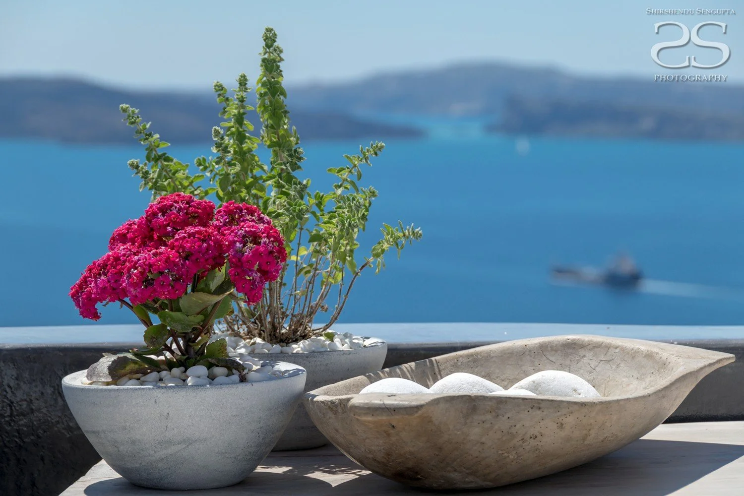 flower pots near white houses church blue domes oia imerovigli firostefani fira village santorini greece caldera volcanic island