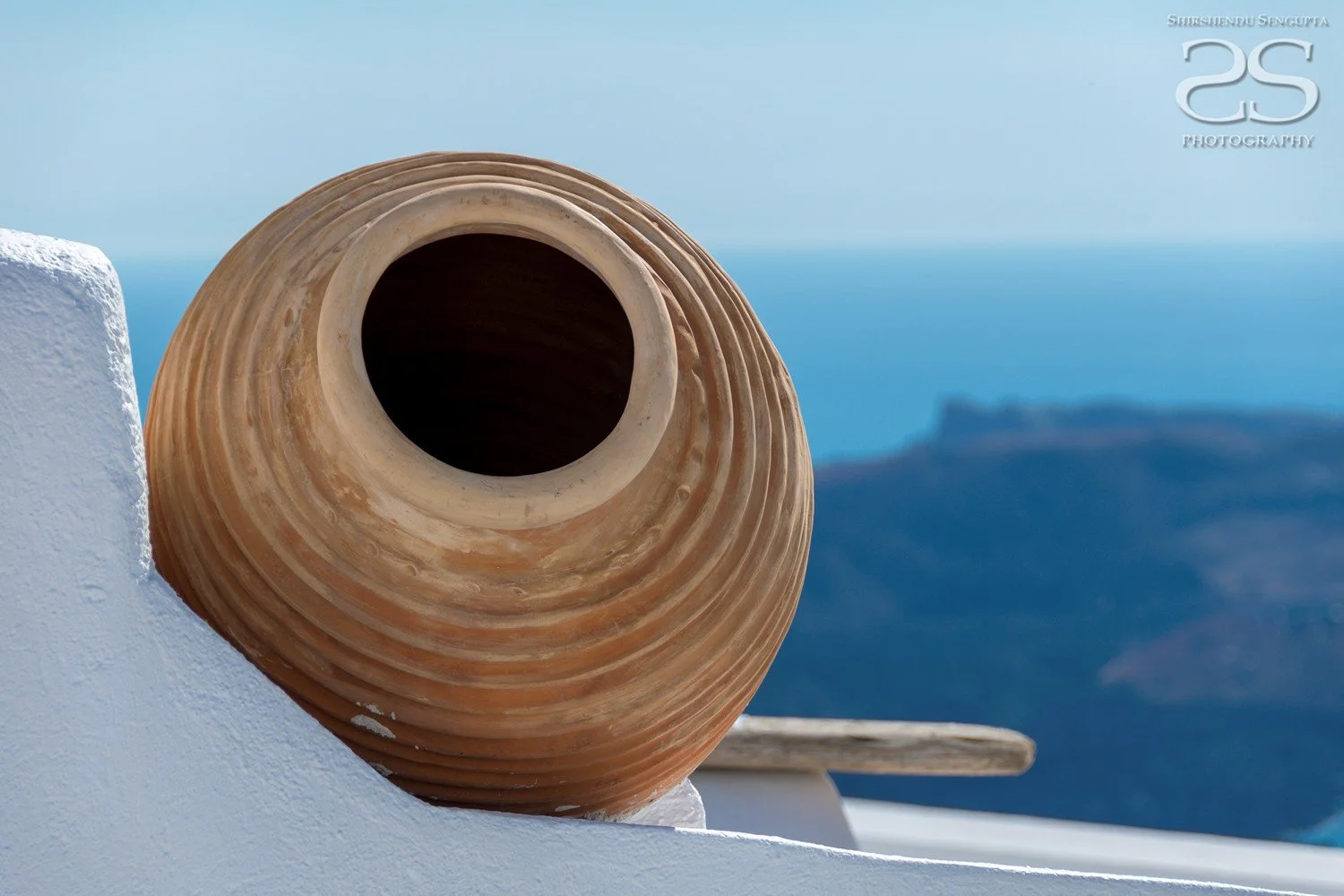 clay pot near white houses church blue domes oia imerovigli firostefani fira village santorini greece caldera volcanic island