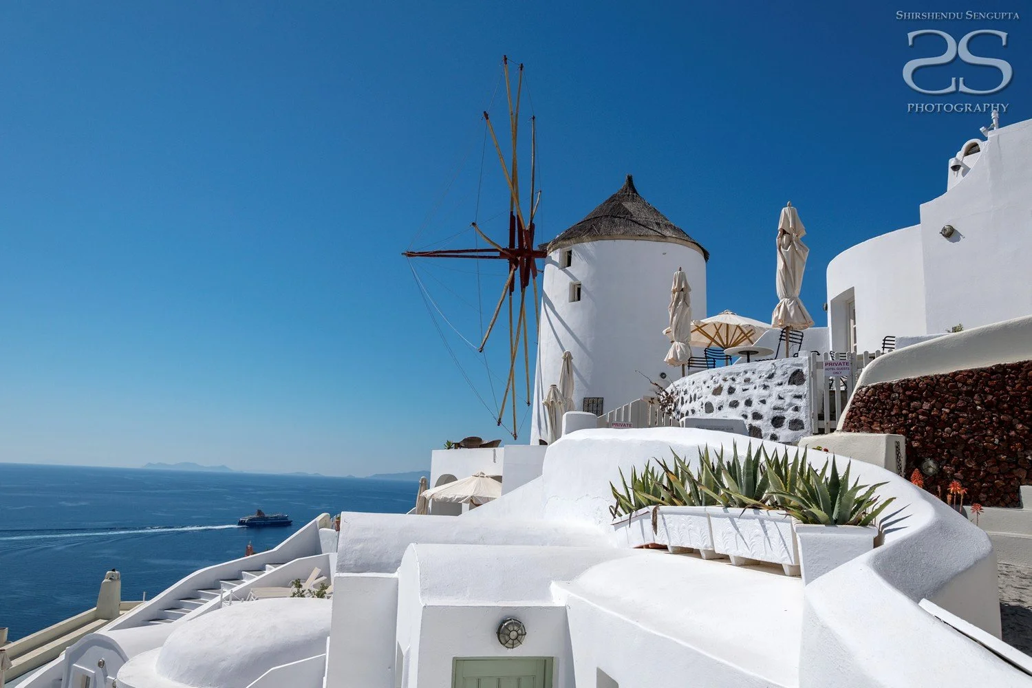 white windmill houses church bell towers blue domes oia imerovigli firostefani fira village santorini greece caldera volcanic island